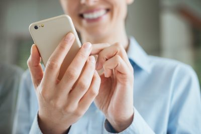 Woman requesting a tree service quote via her mobile phone